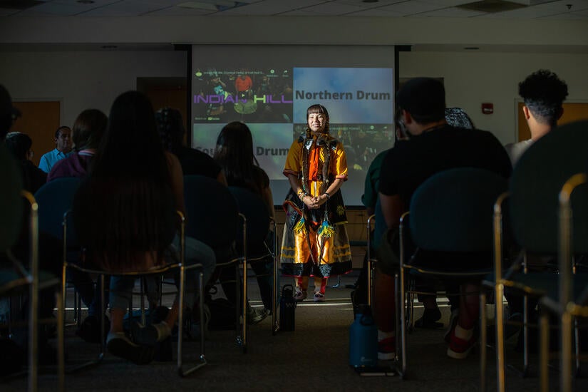 Kaelene Ashmore, 16, shows off her regalia to Native American youth during an activity in the Bear Cave as part of Gathering of the Tribes Summer Residential Program on Thursday, June 27, 2022 at UC Riverside.  (UCR/Stan Lim)