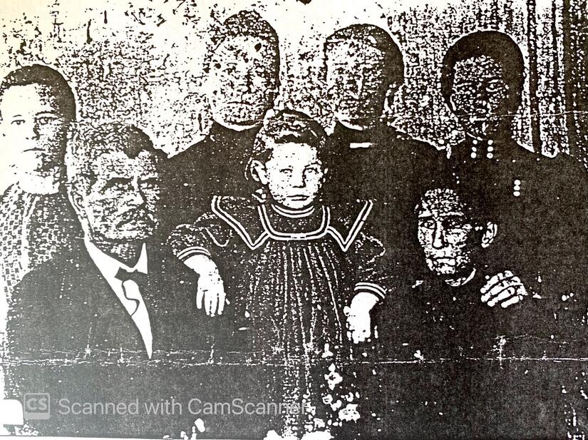 Keith Anger Fuston family photo. R. J. Fuston, bottom left, and Nettie Fuston, second from right, top. The child in the center is the child Nettie gave birth to in 1895. Photo circa 1899. (Photo courtesy of Keith Unger)