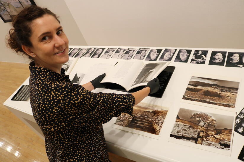 Joanna Szupinska, senior curator at UCR Arts, works on a vitrine display of the “Christina Fernandez: Multiple Exposure” exhibition on Wednesday, September 7, 2022. (UCR/Sandra Baltazar Martínez)  