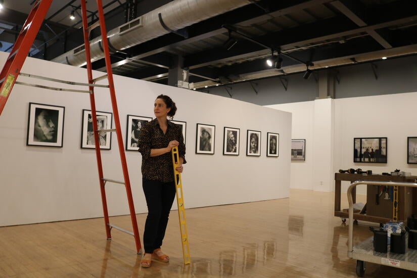 Joanna Szupinska, senior curator of exhibitions at UCR Arts, walking through the exhibition while it was being installed at the California Museum of Photography on Wednesday, September 7, 2022. (UCR/Sandra Baltazar Martínez) 