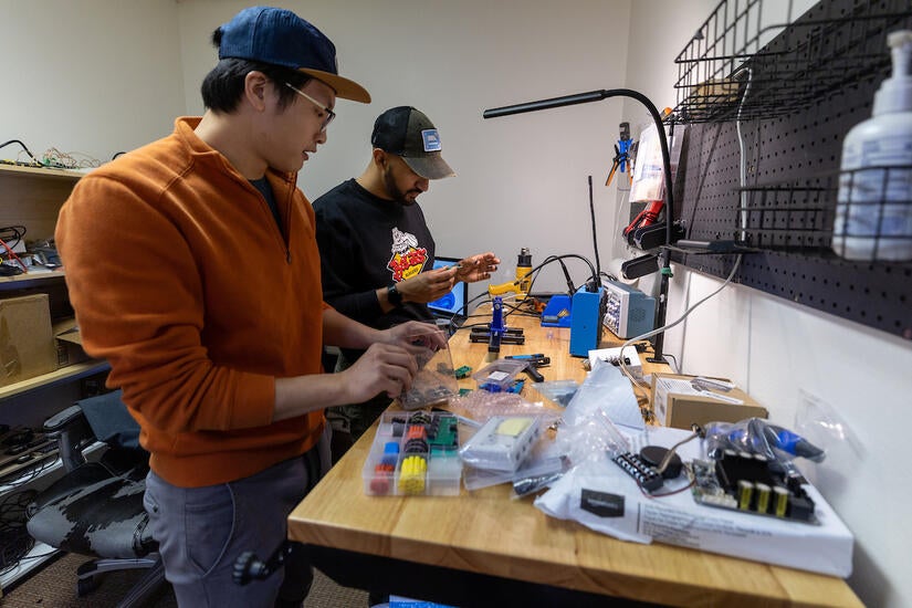 Winson Bi, '21, lead engineer, and Brandon Babu, current master's student in electrical engineering at UCR, work in the lab at EDGE Sound Research in Riverside. (UCR/Stan Lim)