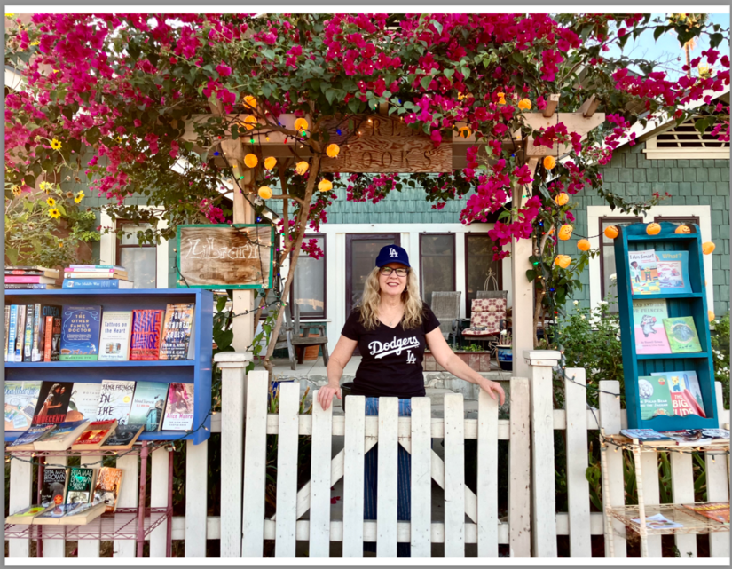 Susan Straight standing by her Fence Library. (Photo courtesy of Susan Straight, Oct. 2024)