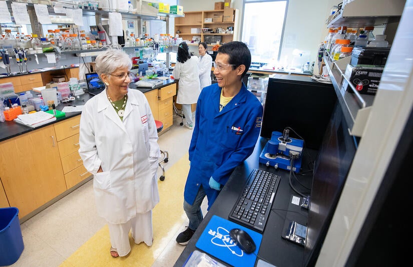 Katayoon "Katie" Dehesh checks in with her lab team on August 15, 2023. (UCR/Stan Lim)