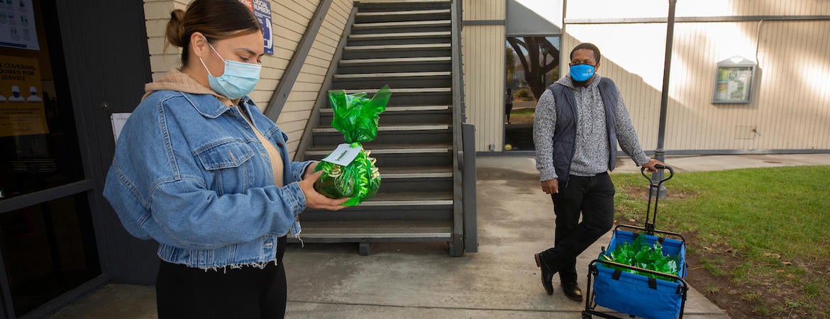 ennifer Guerra, 26, picked up a holiday care package from Guardian Scholars on Monday, December 14, 2020 at UC Riverside. (UCR/Stan Lim)