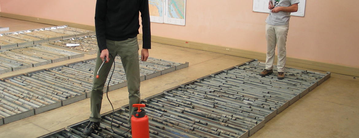 researchers spraying sedimentary rocks