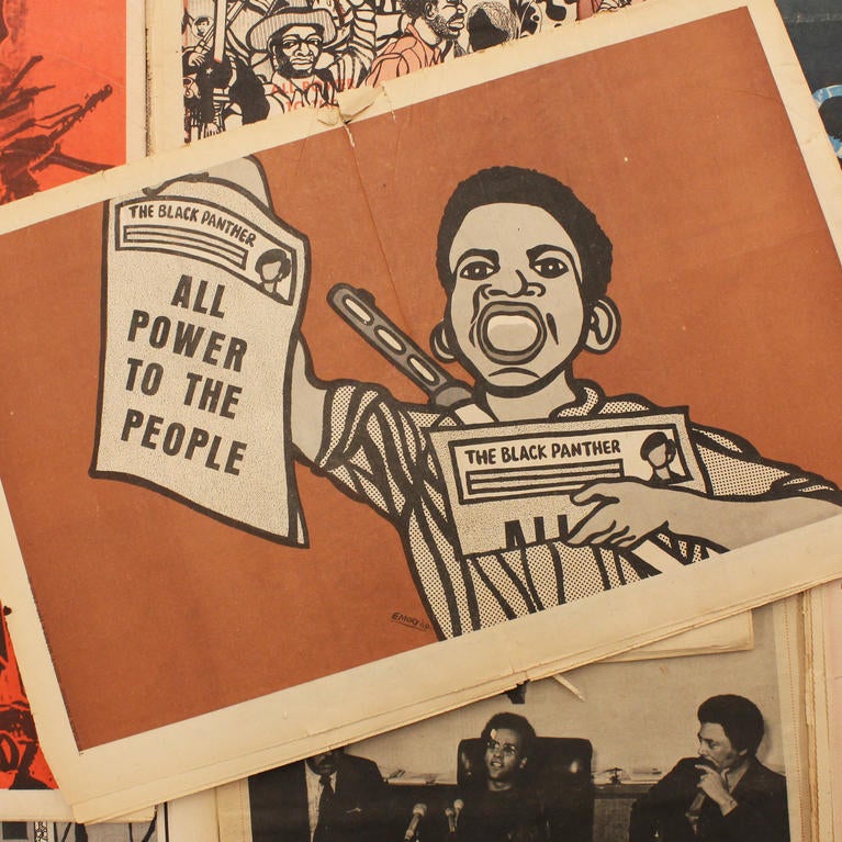 Image of artwork by Emory Douglas featuring a boy holding a paper that reads "All Power to the People". Photo by Essence Harden. Archives of Southern California Library