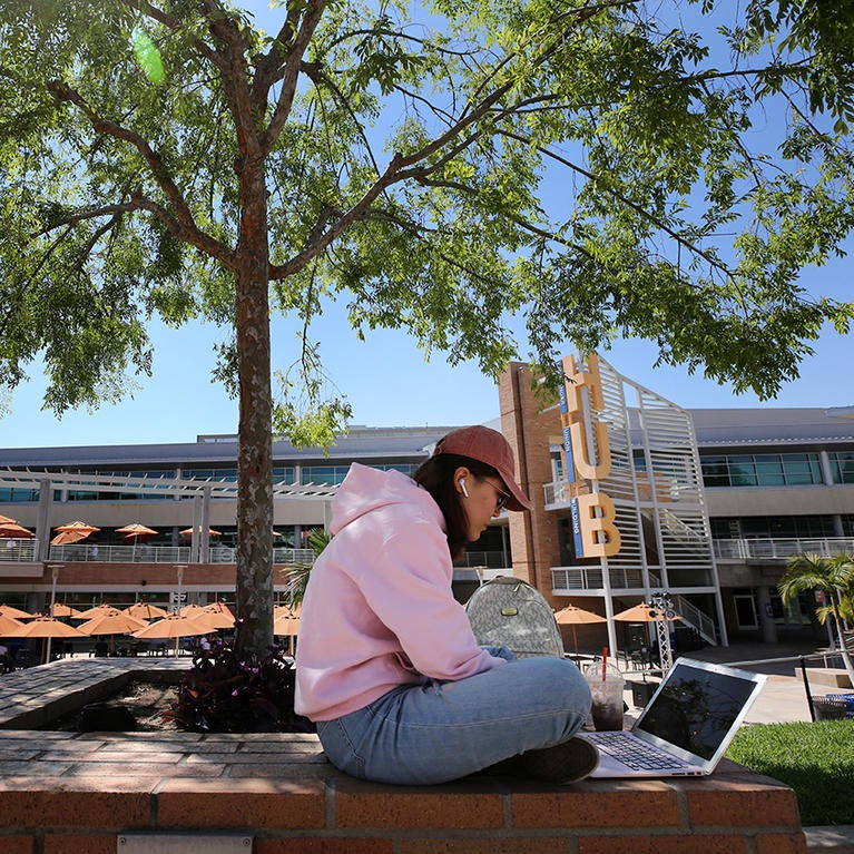 student studying on UCR campus