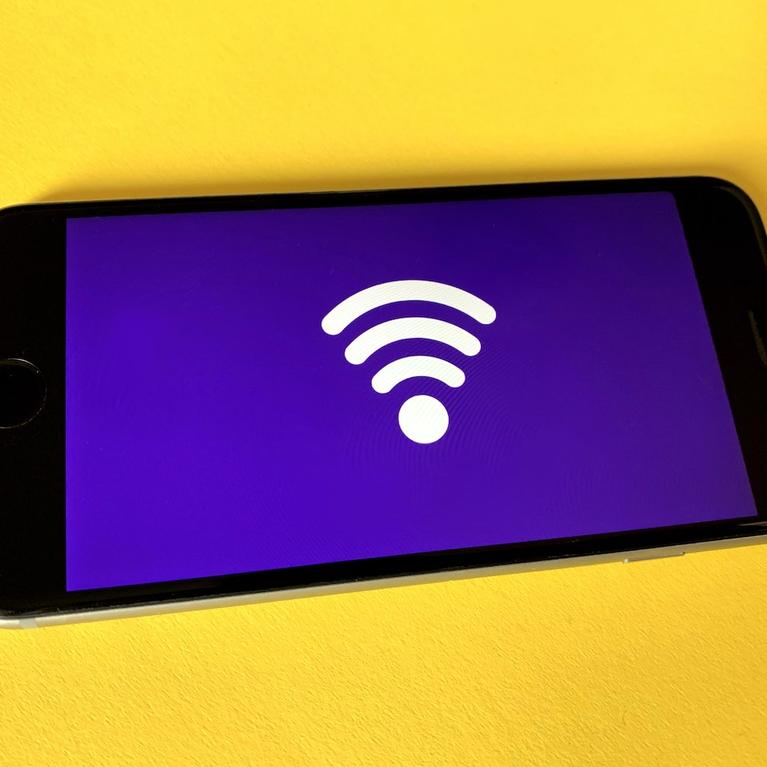 A smartphone displaying an icon representing wireless connectivity