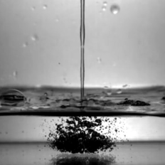 A stream of mezcal making bubbles in a bowl