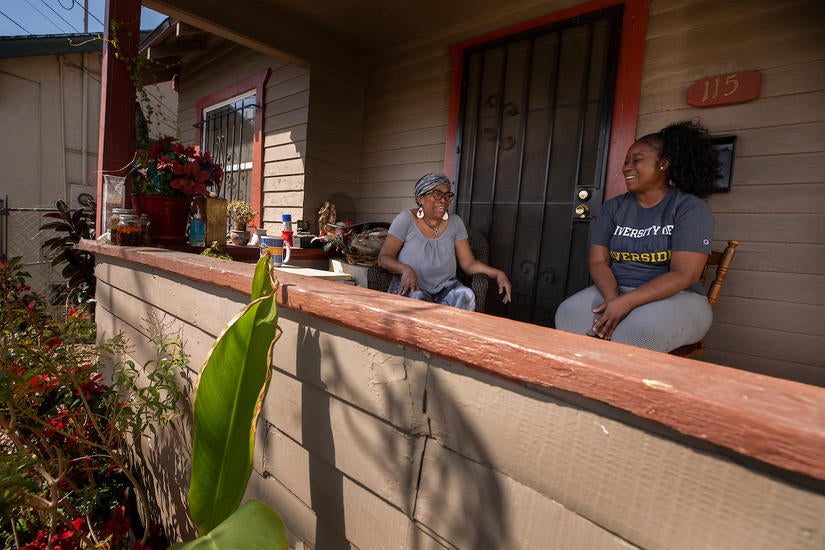 Deidre Reyes, 46, has a laugh with her mother, Sally Reyes, 71, during a visit to her home in Los Angeles on March 24, 2021. (UCR/Stan Lim)