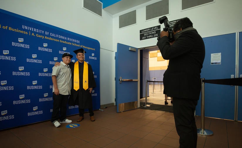 Niko Romero, 22, graduated with a B.S. in finance. He attended commencement with his little brother, Ezekiel Romero, 14, on Saturday, June 12, 2021. (UCR/Stan Lim)
